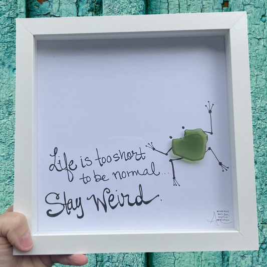 Framed artwork with a green frog and text Life is too short to be normal stay weird sea glass art