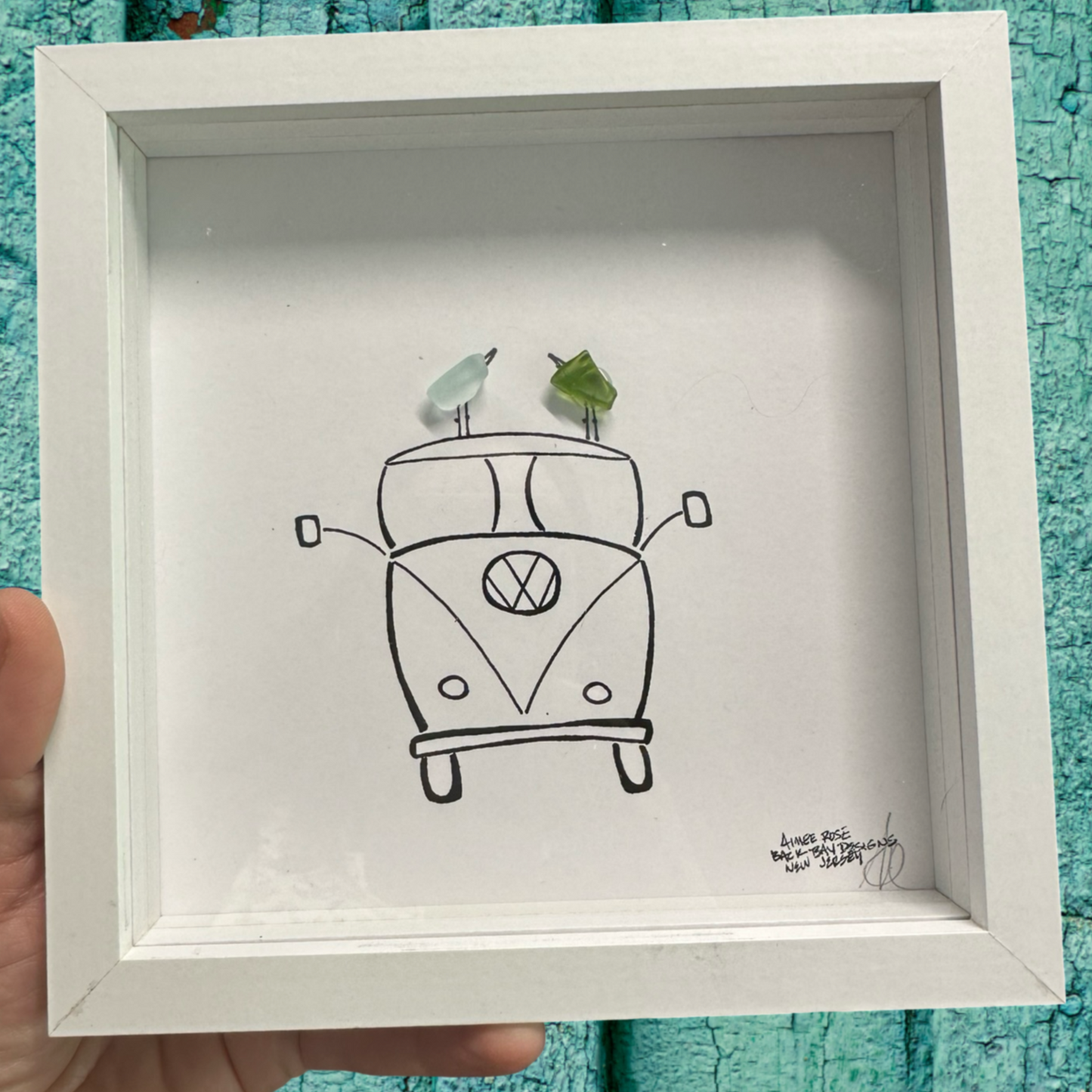 Framed drawing of a Volkswagen van with two birds on top sea glass art