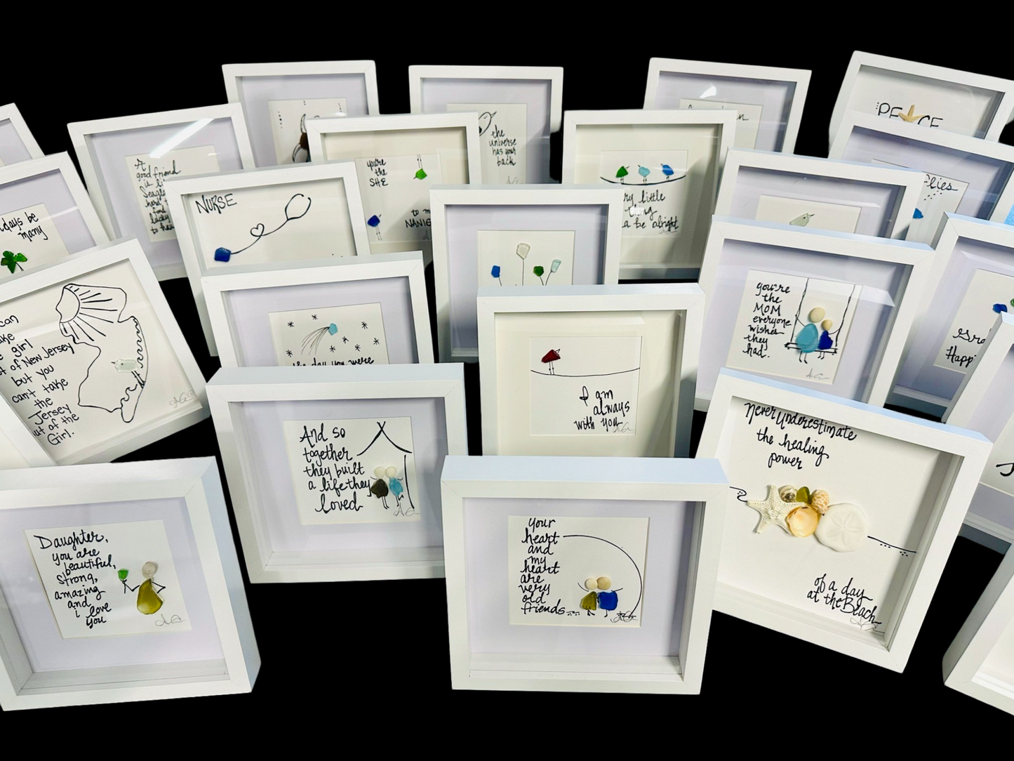 Collection of small framed artworks with various designs and text on a black background