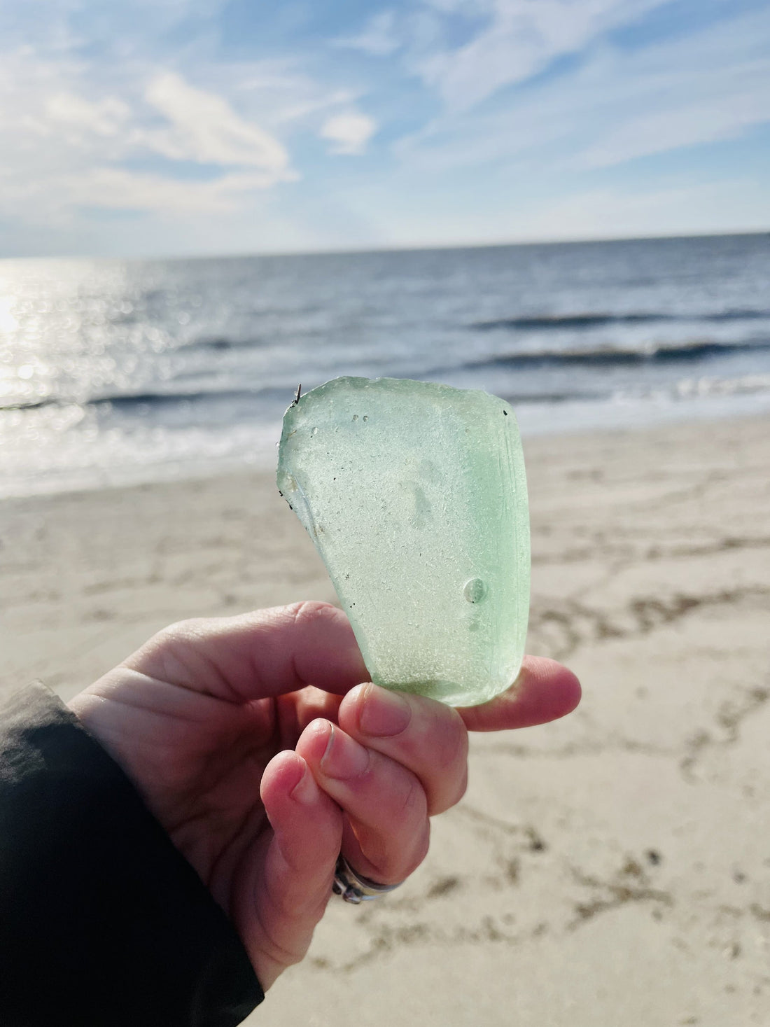 Large piece of sea glass weathered by the ocean found on the bay of Cape May County, New Jersey in winter