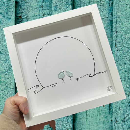 Framed illustration of two birds on a beach at sunset original sea glass art 