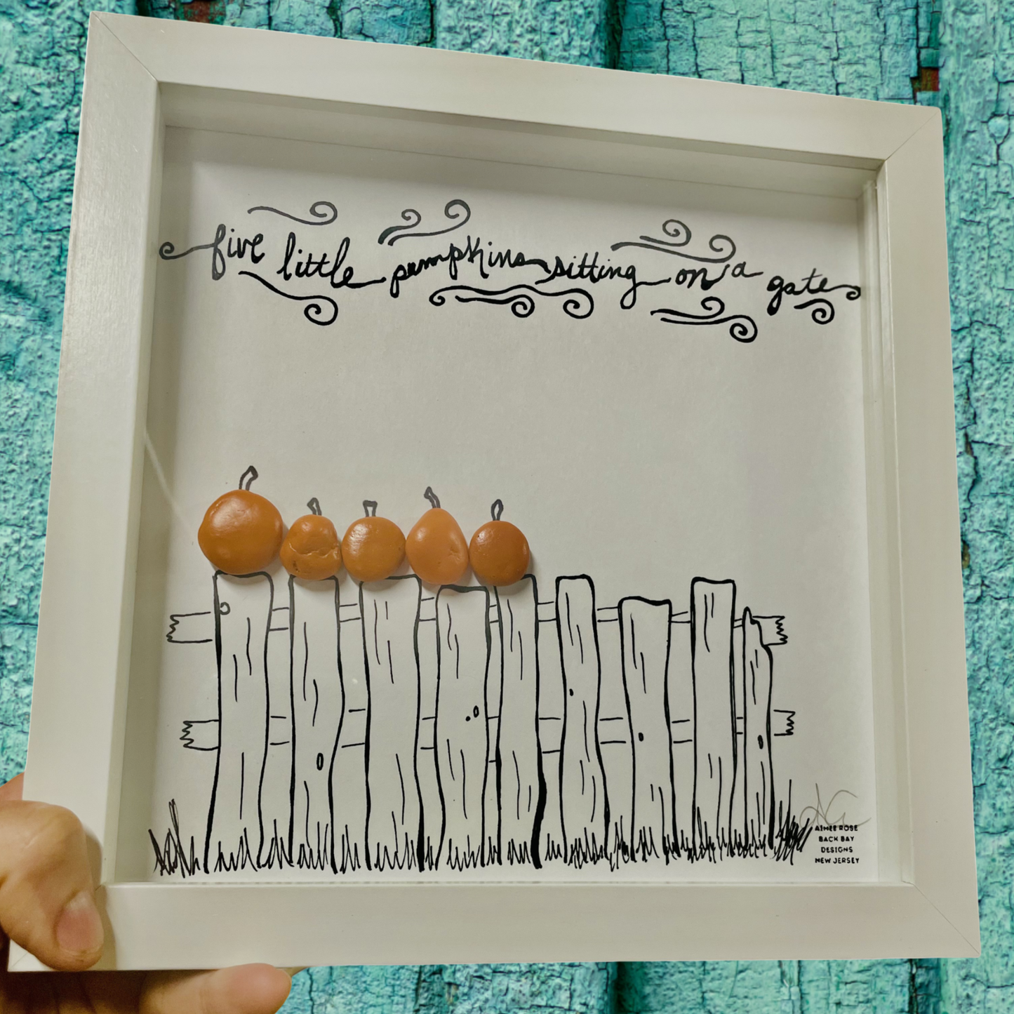 Framed artwork with a drawing of a fence and five pumpkins sea glass art 