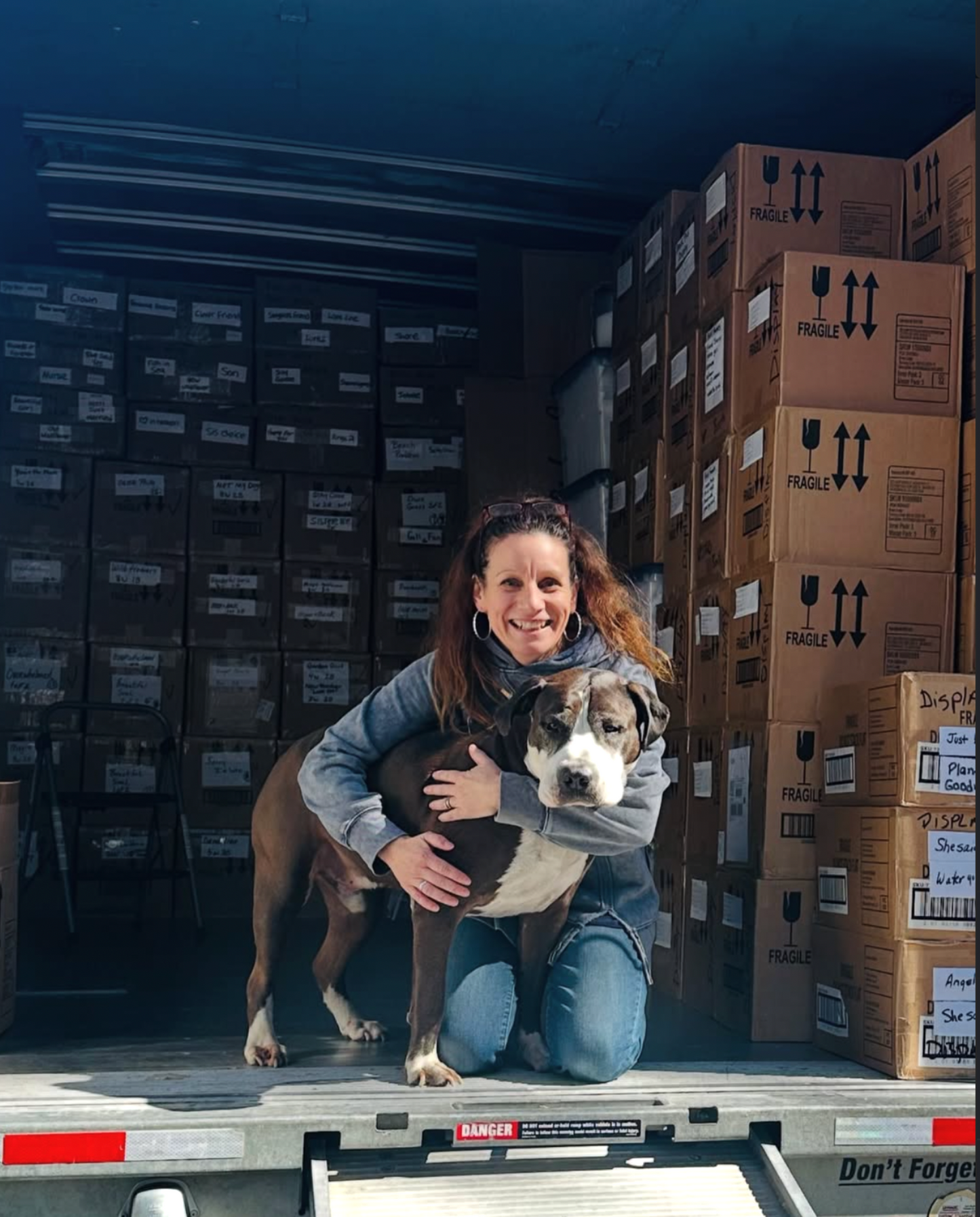 Aimee Hugging Dog in Moving Truck 
