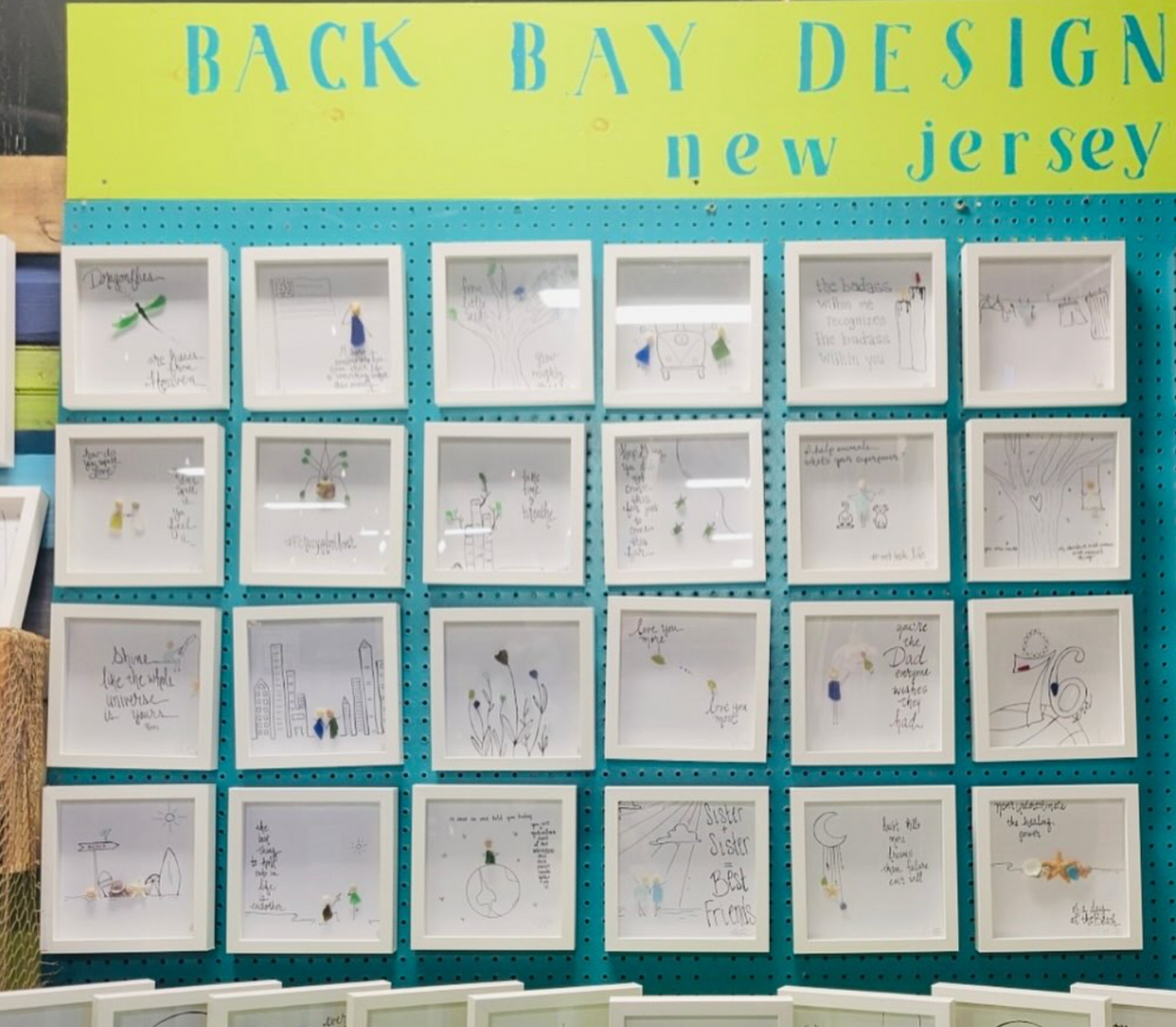 Assorted 8x8 sea glass art on calypso blue and green wall 