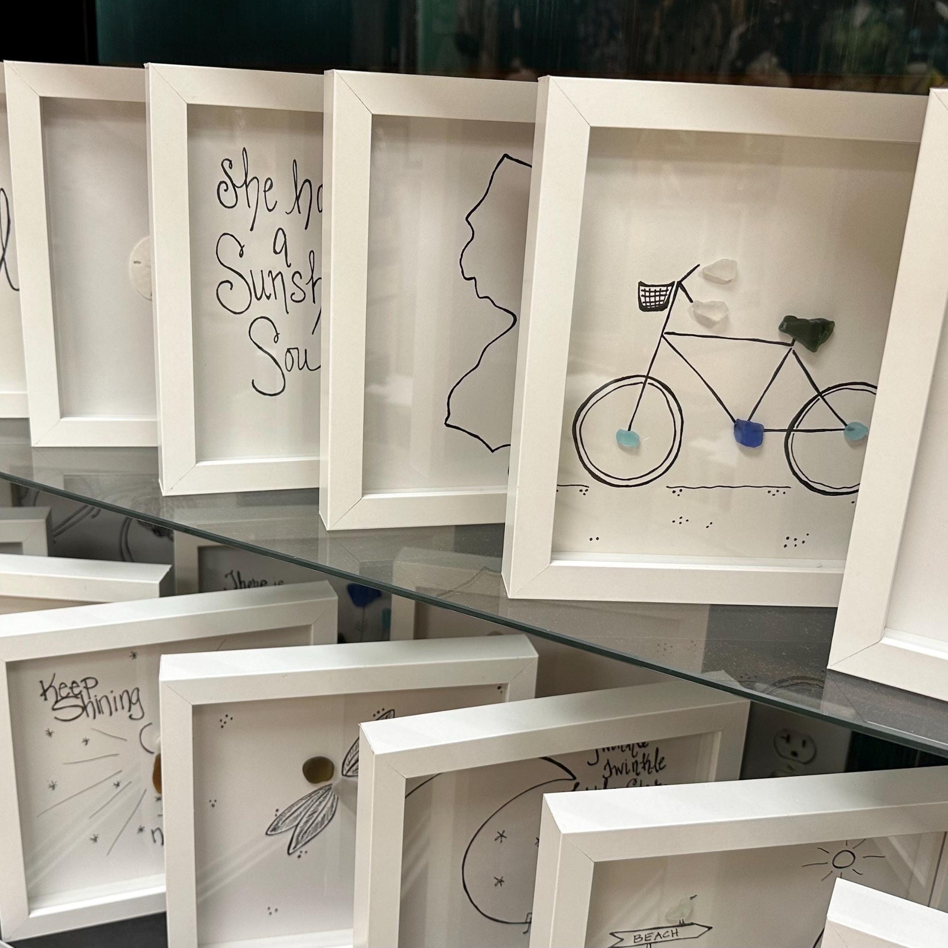  Sea Glass Art by BBD BBD Display_8x8_standing_up_on_2_glass_shelves_bicycle_sea_glass_art