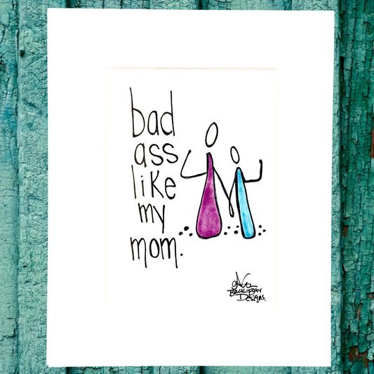 Cartoon illustration with text 'bad ass like my mom' on a white background with teal wooden border