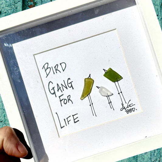 Image: Two big green birds and one small white bird

Quote: "Bird Gang For Life"

Gifts for Eagles Fans, Football fans, Sport Fans, Philly pride, Philly girl
Frames 6x6 inch sea glass artwork by back bay designs 