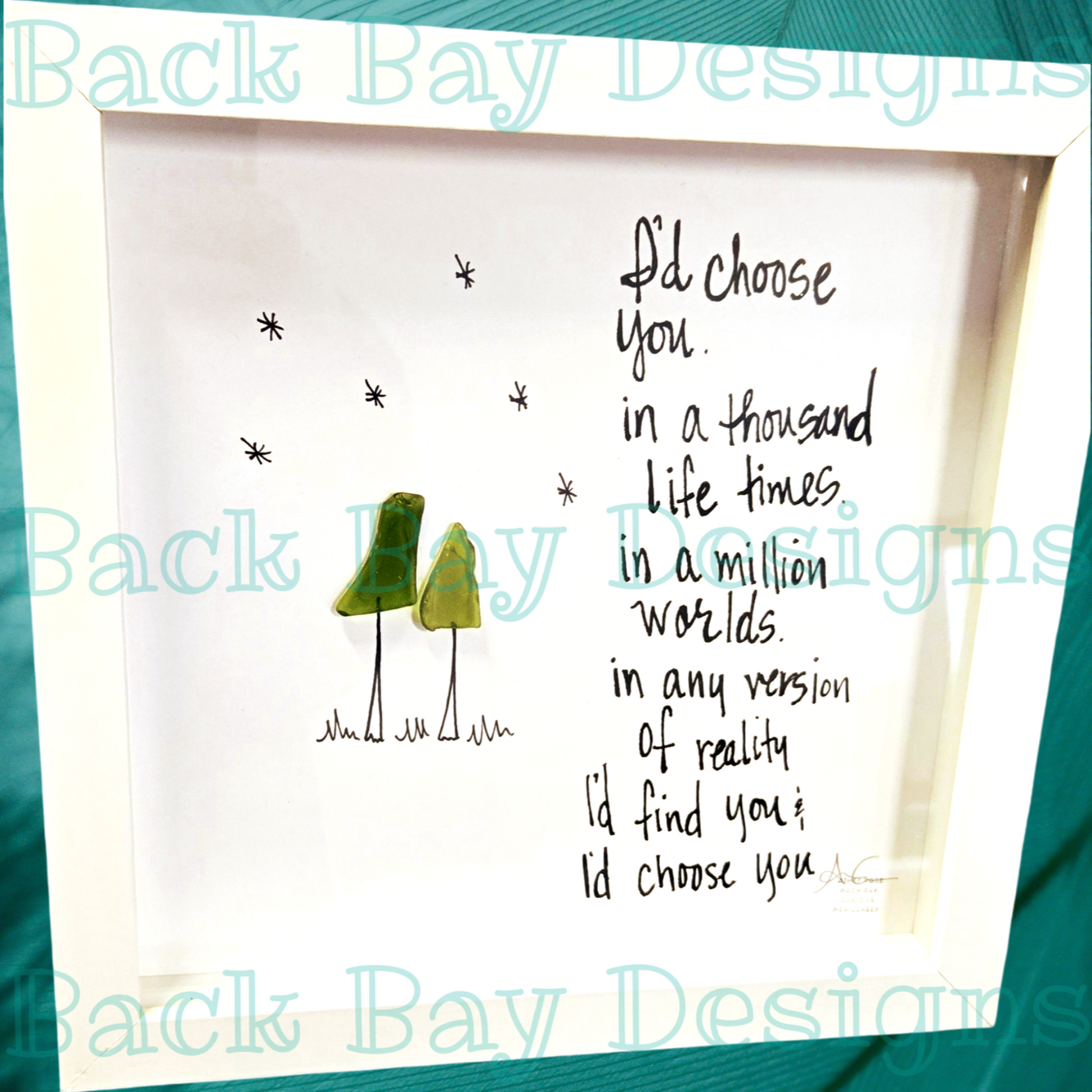 An 8 x 8 shadowbox frame with seaglass art and text that reads 'I'd choose you in a thousand life times in a million worlds. In any version of reality i'd find you and i'd choose you. sea glass art 