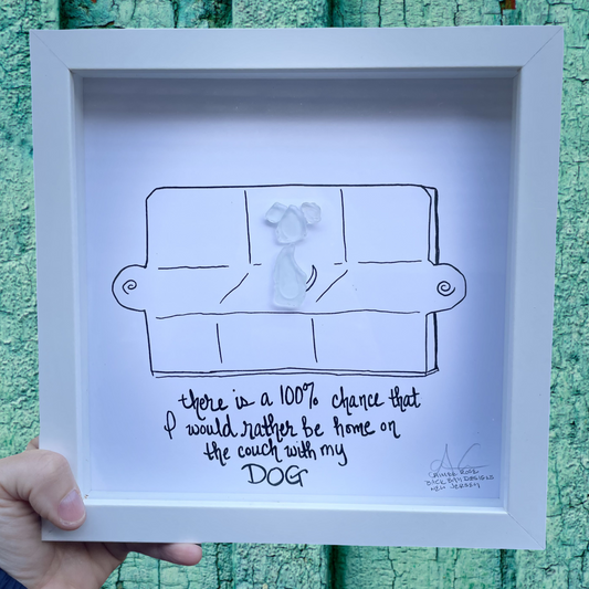 Framed artwork with a drawing of a person on a couch and text, 100% chance id rather be on the coach with my dog sea glass art 