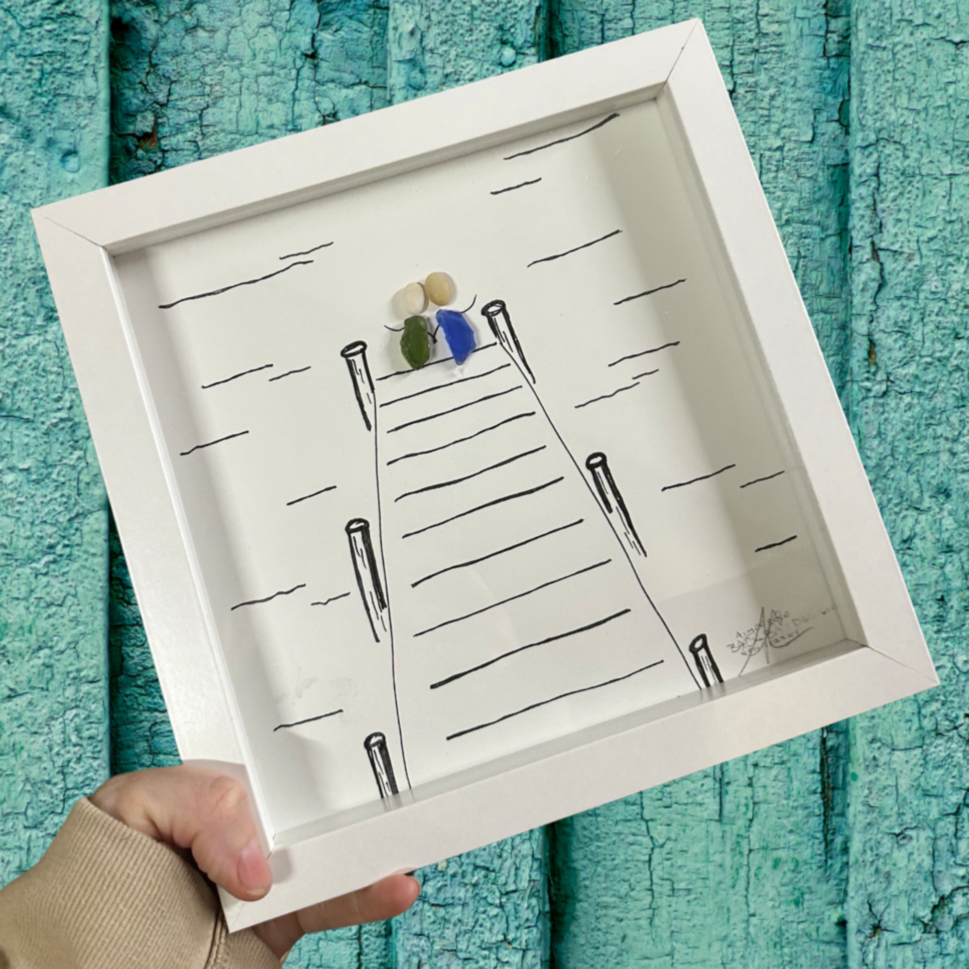 Framed artwork of a Dock with small figures Sea glass art 