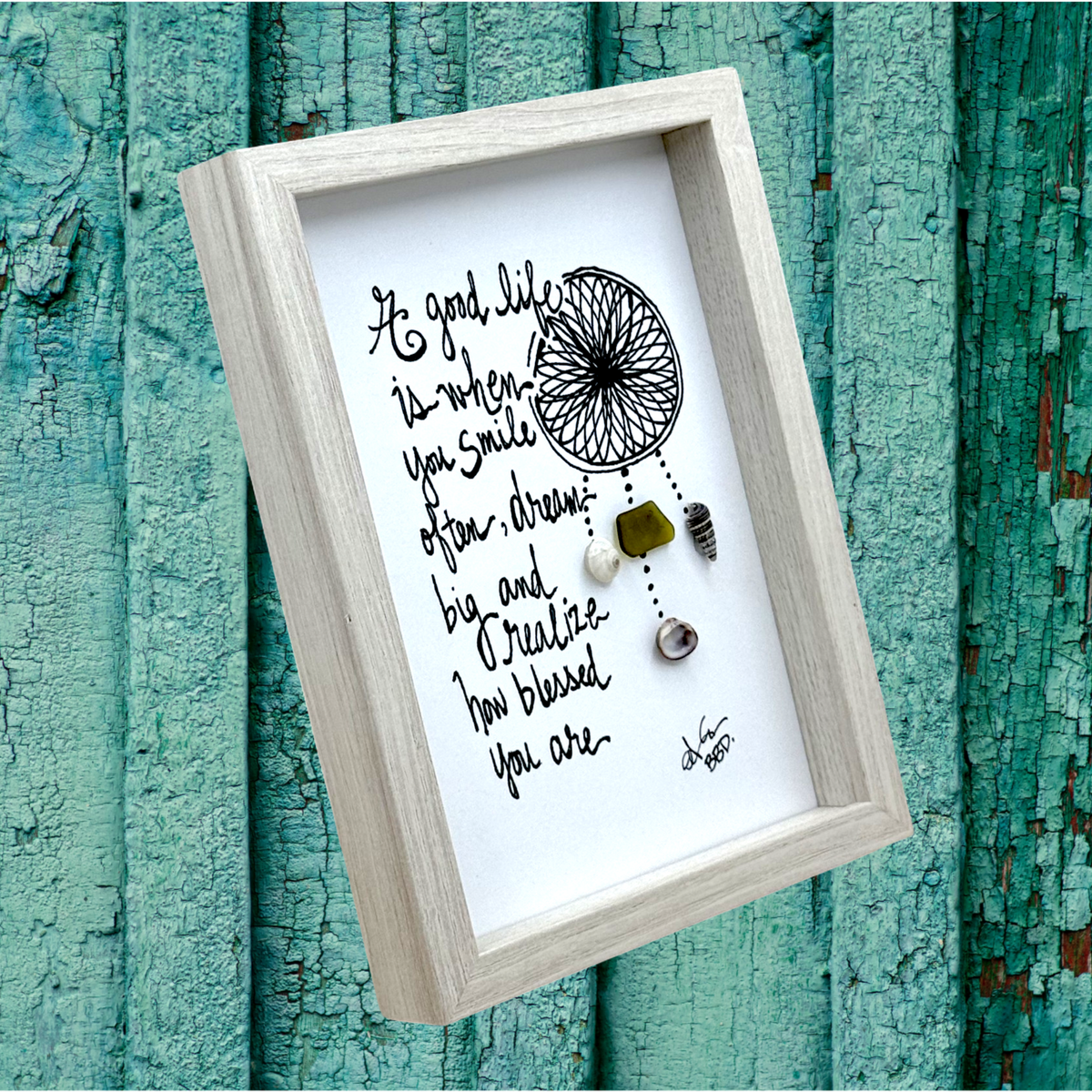 Quote: "A good life is when you smile often, dream big and realize how blessed you are" Image: Hand-drawn dreamcatcher with sea glass and seashells hanging from beaded strands
