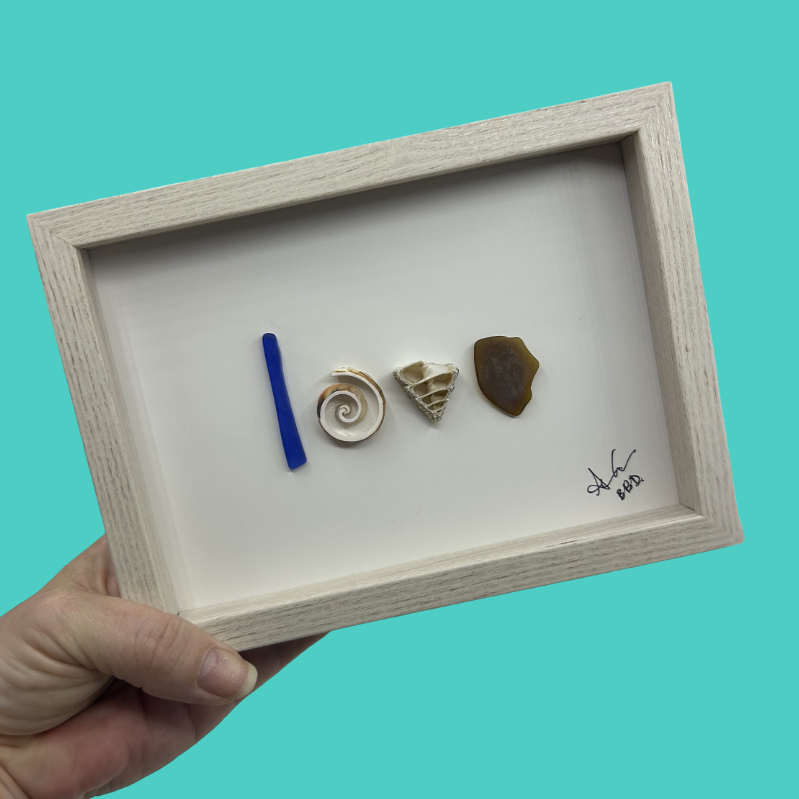 love written in shells and sea glass 
