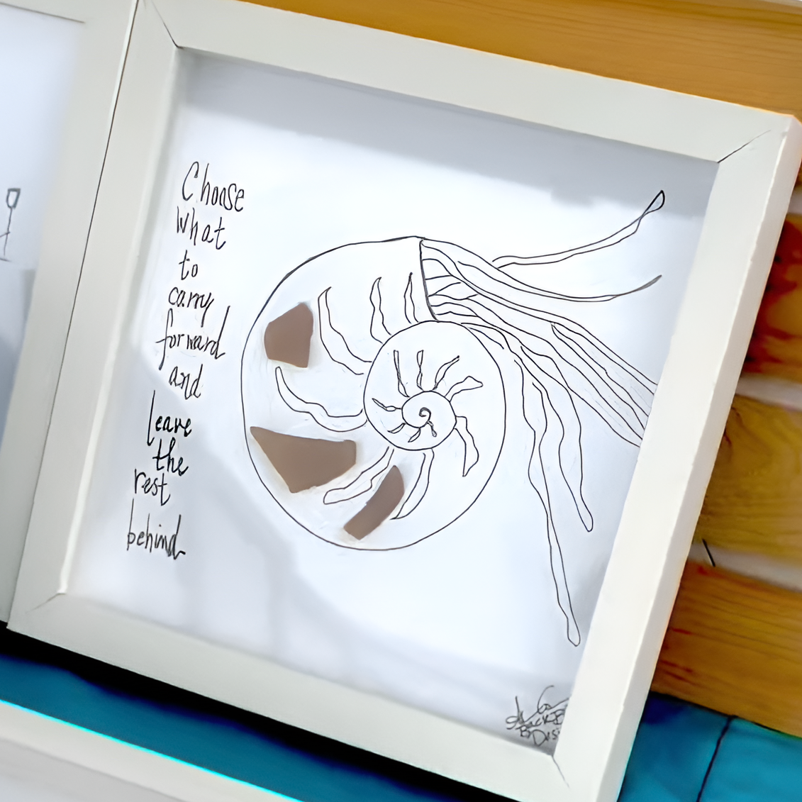 "Choose what to carry forward and leave the rest behind." Hand drawn nautilus shell with sea glass shell --Nautilus_8in_on_table_upscale_preferred square shadow 