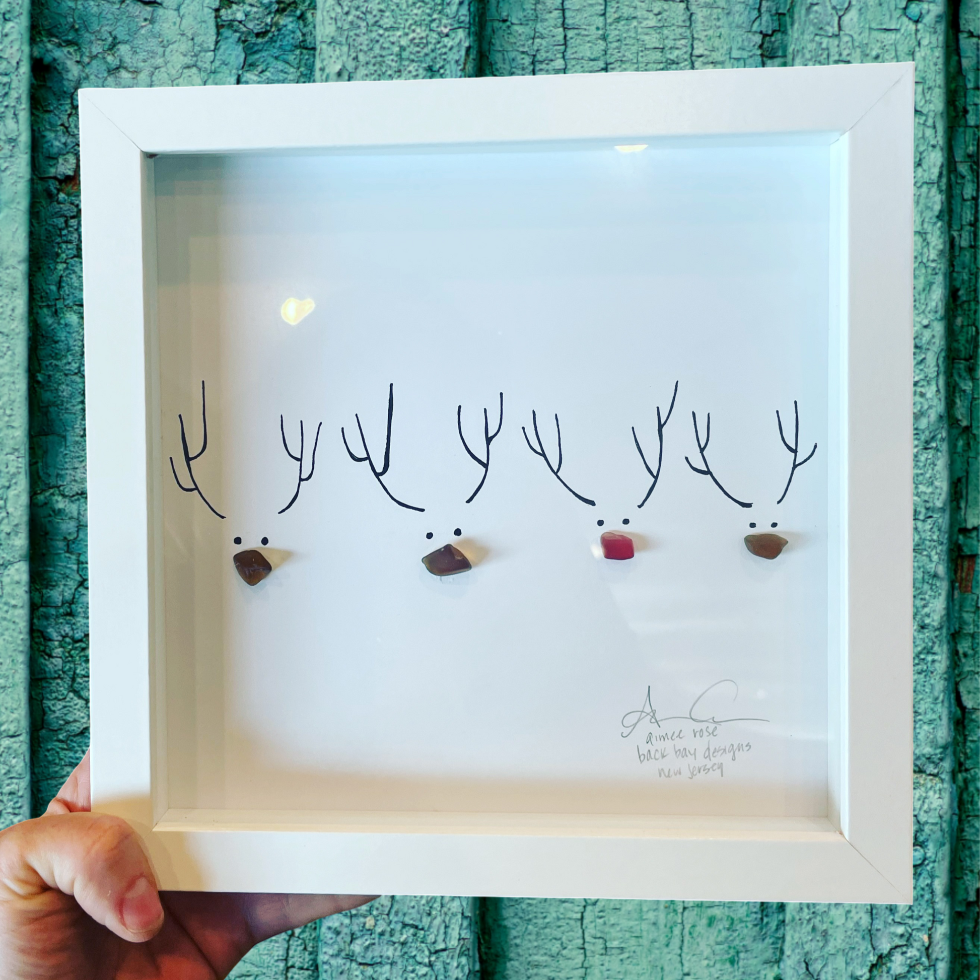 Framed artwork of reindeer with antlers on a textured teal wall. Sea Glass art for Christmas and Winter Holiday 