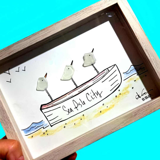 SIC rowboat 5x7 brighterhandheld_upscale_Teal_ZOOM in "Sea Isle City" on side of rowboat - 3 sea glass birds perched on hand hand drawn rowboat at beach with colorful waves and 4 birds flying overhead 