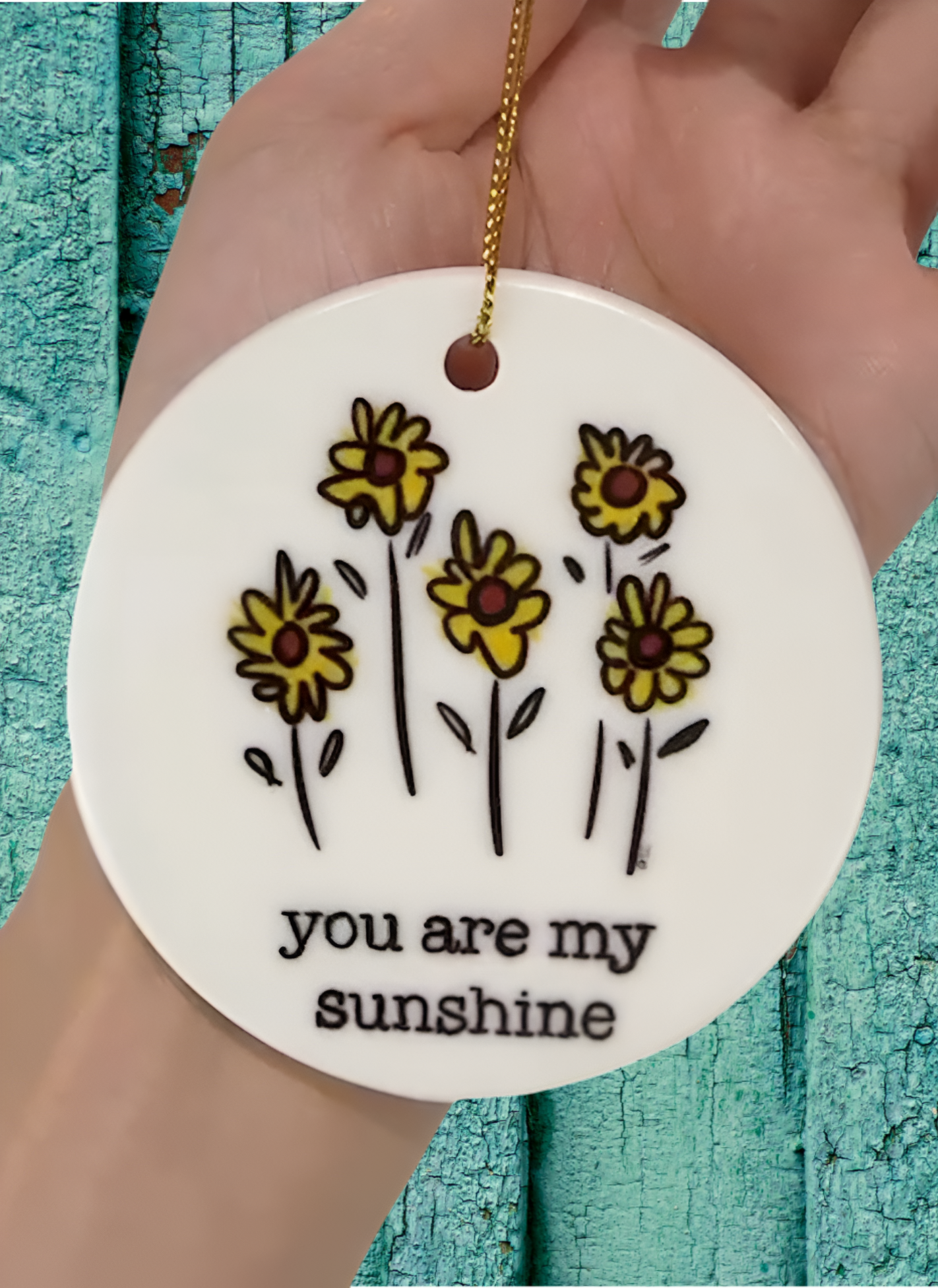Round white ornament with yellow flowers and 'you are my sunshine' text, original back bay design