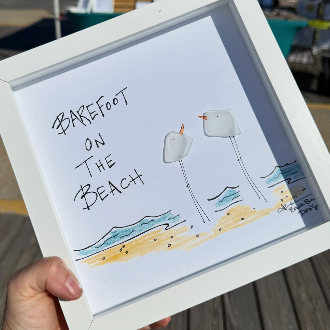 barefoot_on_the_beach_hand_held_on_boardwalk_ square 