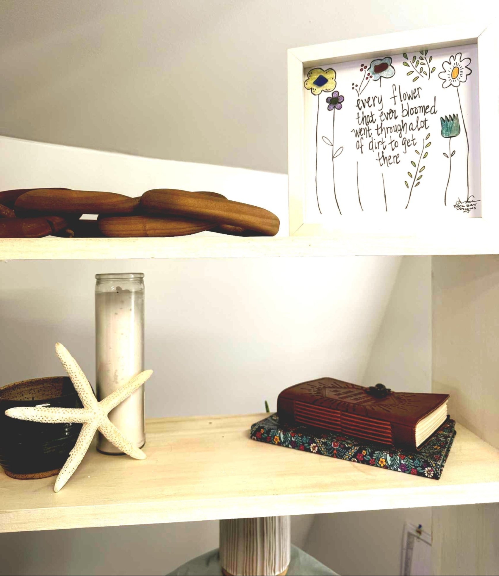 flowers_through_dirt on shelf white 8in sea glass art with candle starfish book wood links