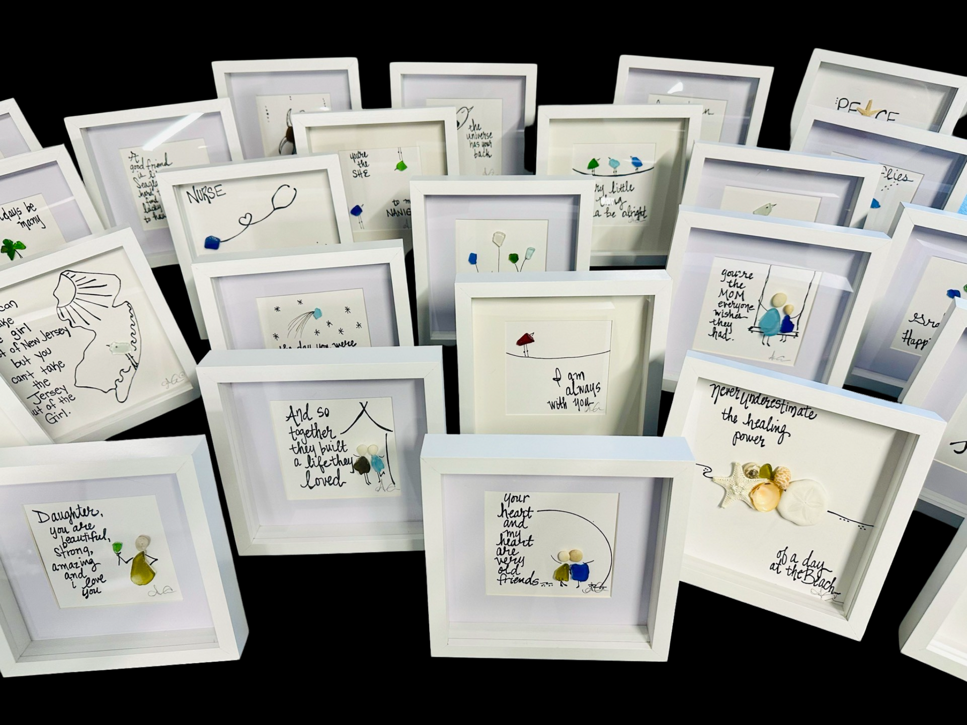 Collection of small framed artworks with various designs and text on a black background