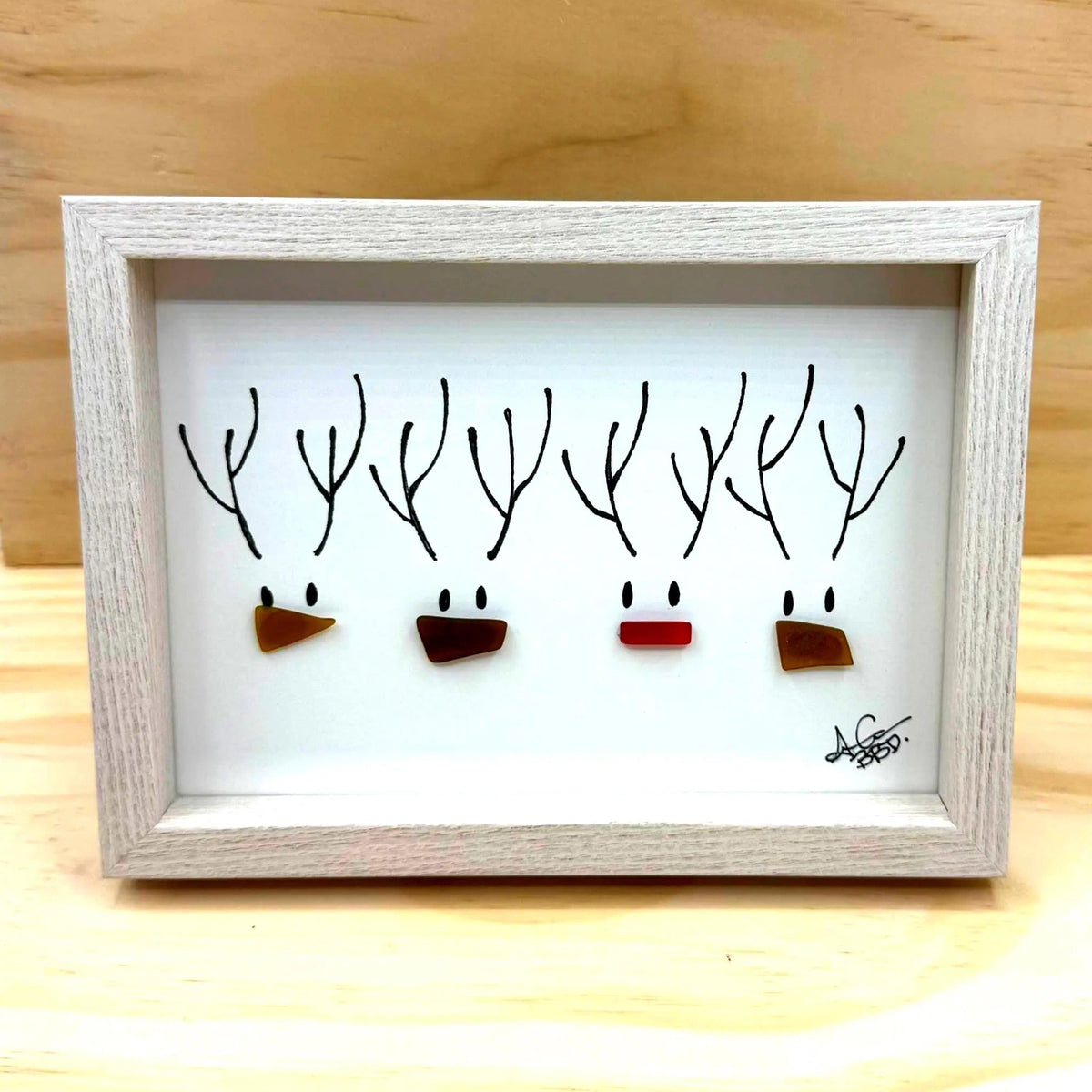 4 reindeer heads with hand drawn antlers and sea glass noses, including one red rudolf nose, and 3 brown reindeer friends' noses.  Beyond Words, Image Only, No Words 