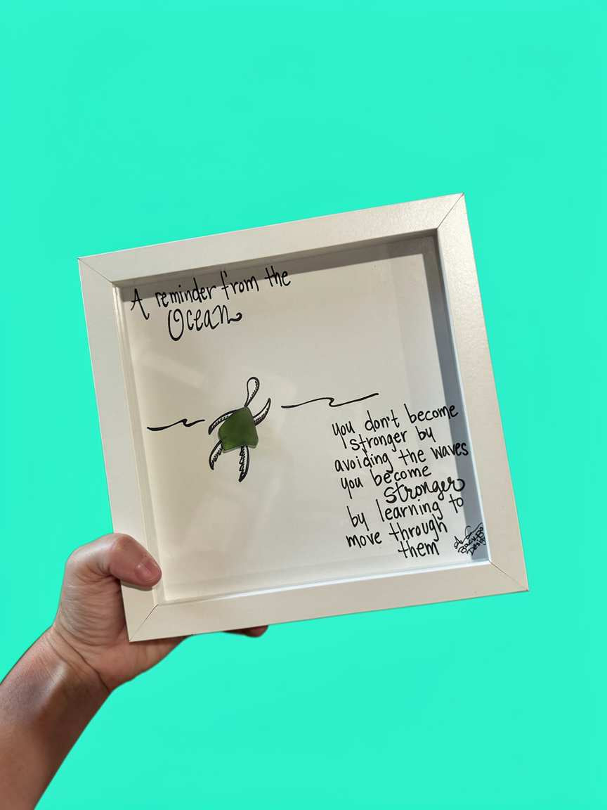 "A reminder from the ocean: you don't become stronger by avoiding the waves, you become stringer by learning to move through them." Sea glass sea turtle swimming in hand drawn waves 